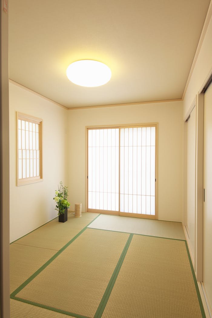 Elegant Japanese-style room with tatami mats and wooden sliding doors.